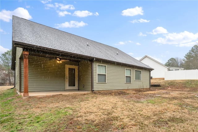 rear view of property featuring a yard and a patio area