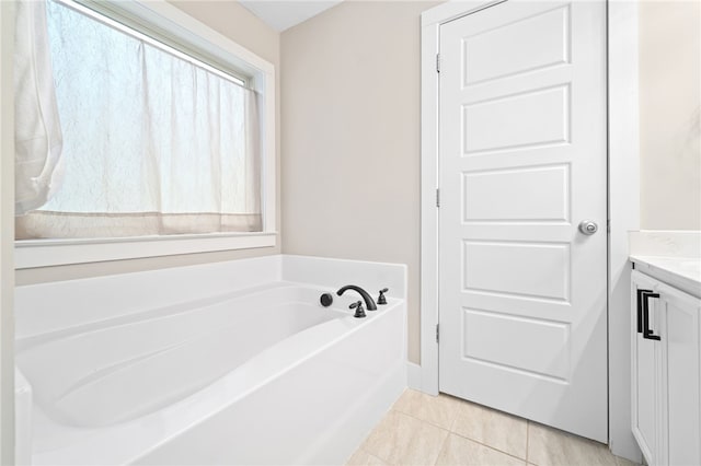 bathroom featuring vanity, a tub to relax in, and tile patterned flooring