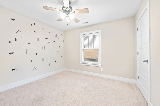 carpeted empty room featuring ceiling fan