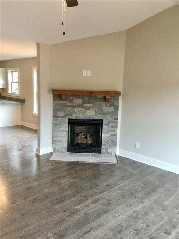 unfurnished living room featuring hardwood / wood-style floors, a fireplace, and ceiling fan