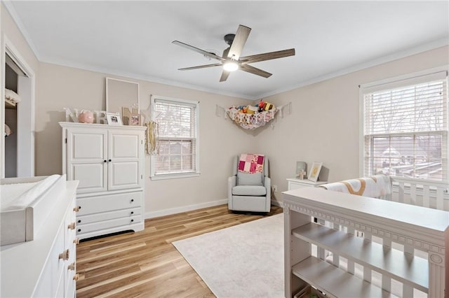 bedroom featuring crown molding, ceiling fan, and light hardwood / wood-style flooring