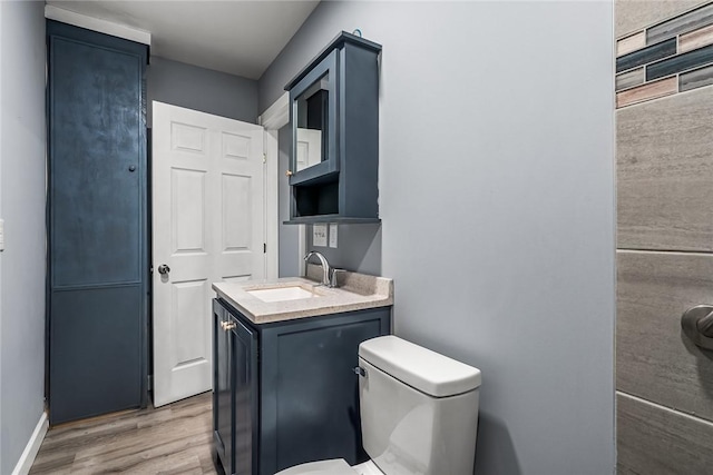 bathroom featuring hardwood / wood-style flooring, vanity, and toilet