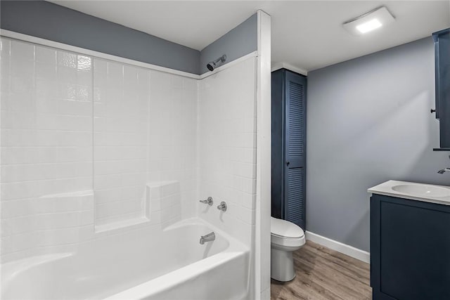 full bathroom with hardwood / wood-style flooring, shower / tub combination, vanity, and toilet