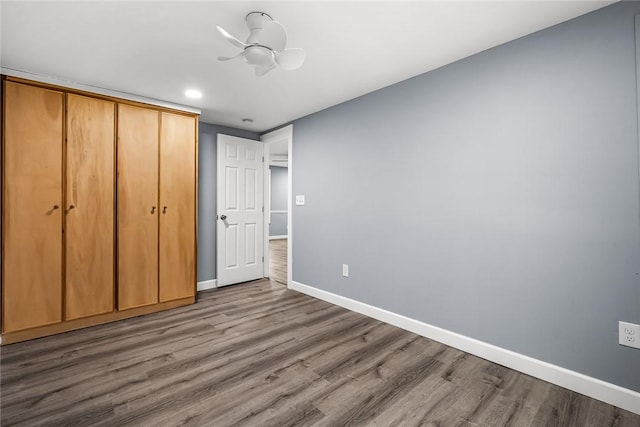 unfurnished bedroom featuring wood-type flooring and a closet