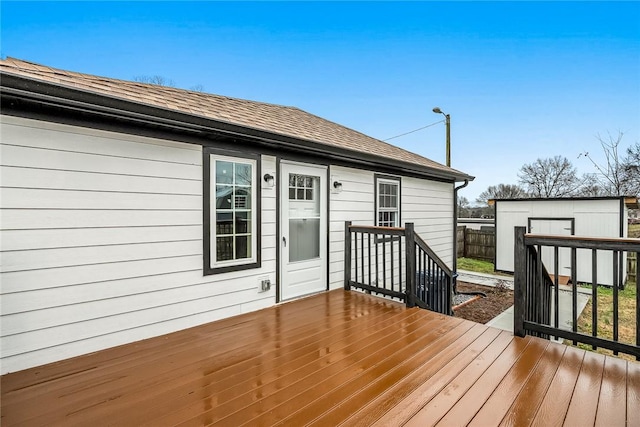 wooden terrace featuring a storage shed