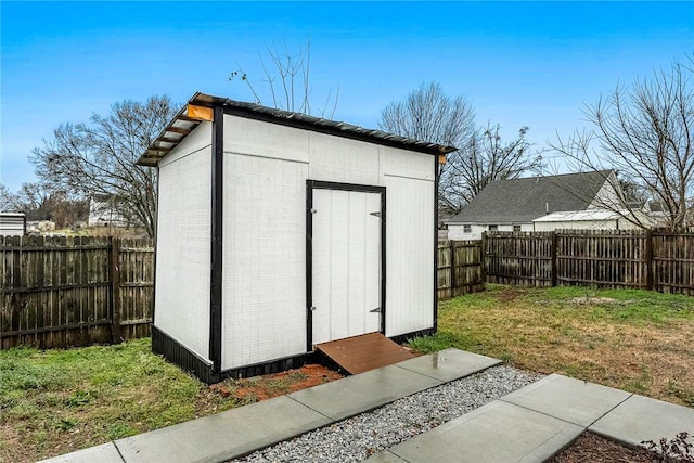 view of outbuilding featuring a lawn