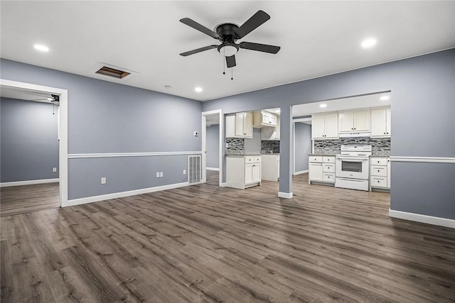 unfurnished living room with dark wood-type flooring and ceiling fan