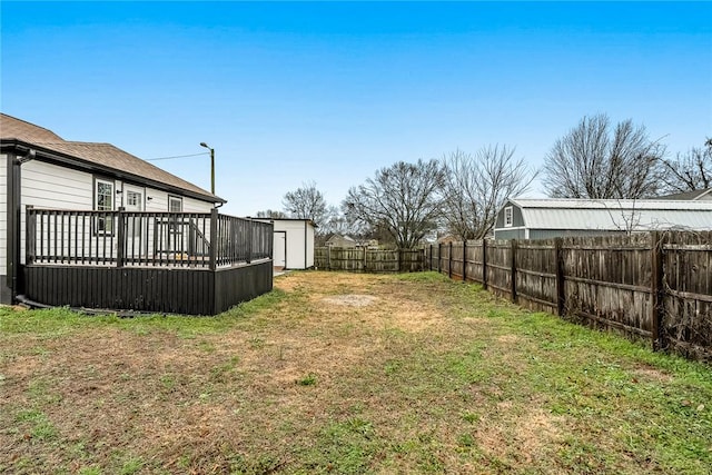 view of yard featuring a shed and a deck