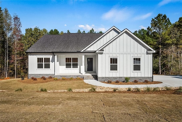 modern farmhouse with a front lawn