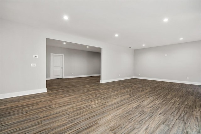 unfurnished room with dark wood-type flooring