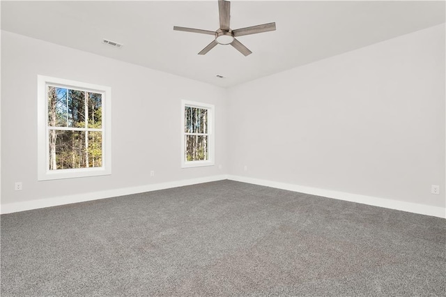 carpeted spare room featuring ceiling fan