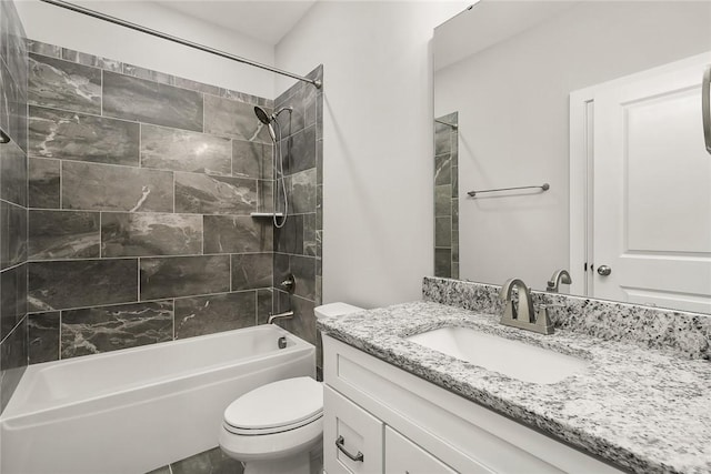 full bathroom with tiled shower / bath combo, vanity, and toilet