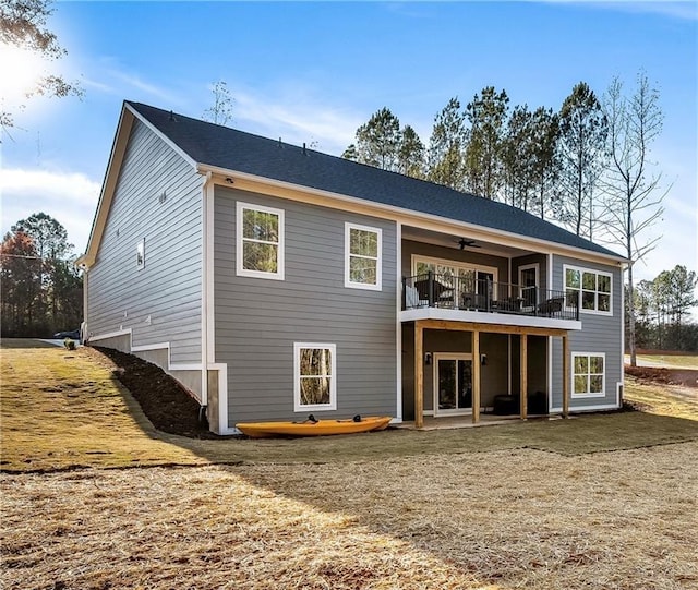 back of property with ceiling fan, a yard, and a patio