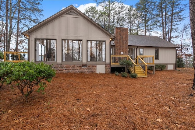 rear view of house featuring a deck