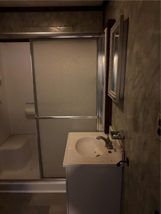 bathroom featuring vanity, tile patterned flooring, and a shower with shower door