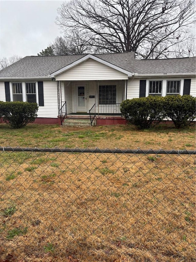 ranch-style house with a front yard and covered porch