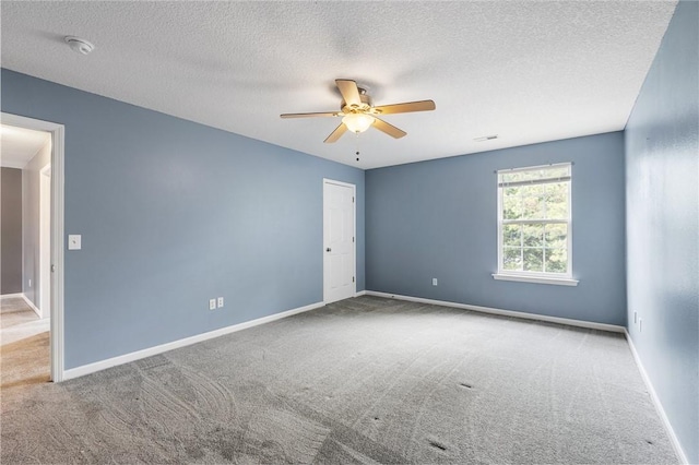 spare room with light carpet, a textured ceiling, and ceiling fan