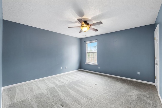 unfurnished room featuring a textured ceiling, ceiling fan, and carpet