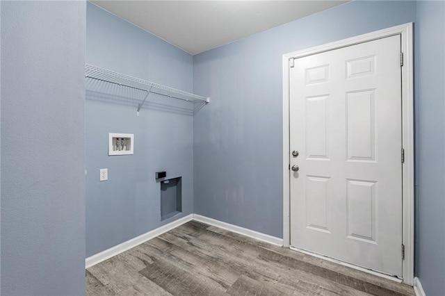 clothes washing area featuring hookup for a washing machine and light hardwood / wood-style floors