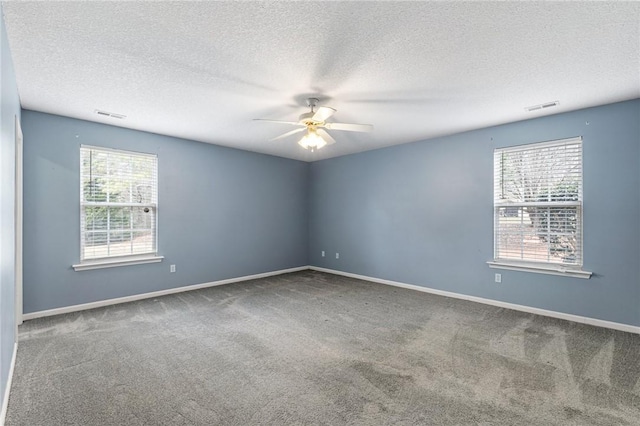 carpeted empty room featuring a textured ceiling and ceiling fan