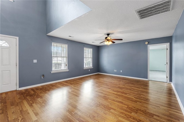 interior space featuring hardwood / wood-style floors, a textured ceiling, and ceiling fan