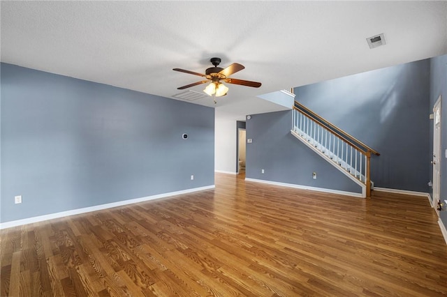 unfurnished living room with wood-type flooring and ceiling fan