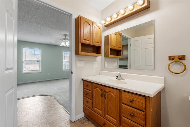 bathroom featuring vanity, a textured ceiling, and ceiling fan