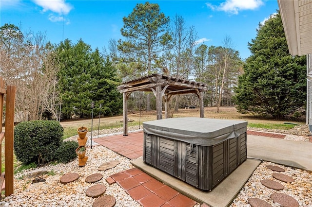 view of patio with a hot tub and a pergola