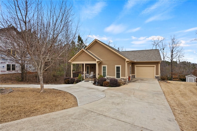 view of front of house featuring a shingled roof, concrete driveway, stone siding, an attached garage, and a porch