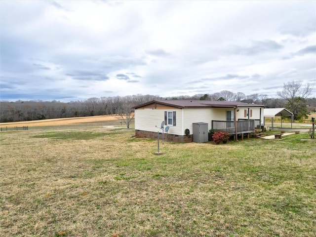 view of property exterior featuring a yard, a carport, and a deck