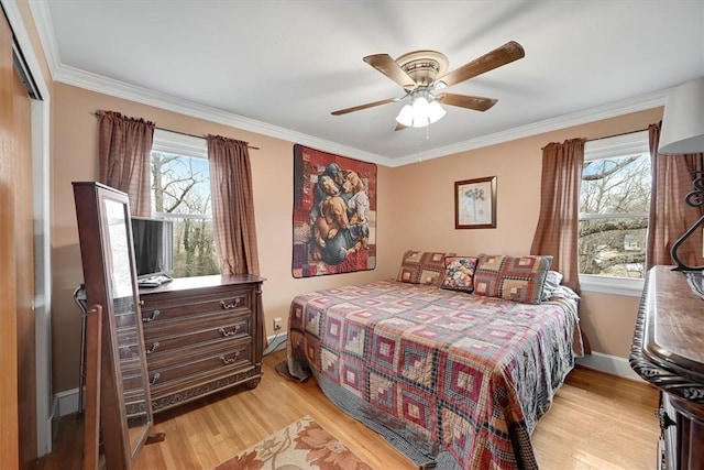 bedroom with multiple windows, crown molding, and light hardwood / wood-style floors