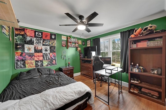 bedroom featuring crown molding, ceiling fan, and wood-type flooring