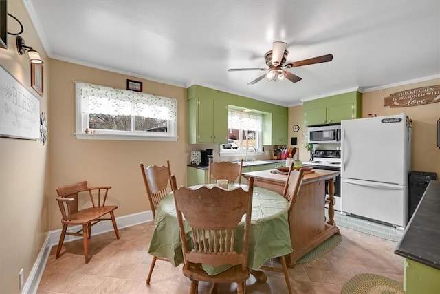 dining space with ceiling fan and ornamental molding