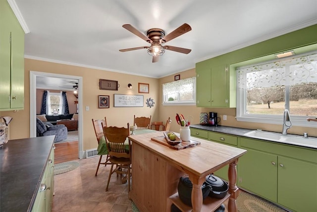 kitchen featuring ornamental molding, sink, ceiling fan, and green cabinetry