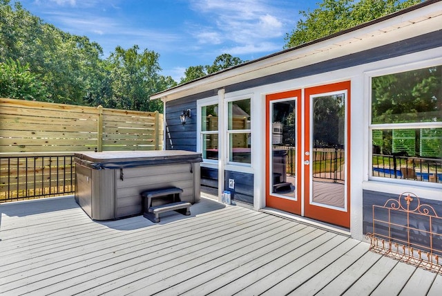 wooden terrace featuring a hot tub and french doors