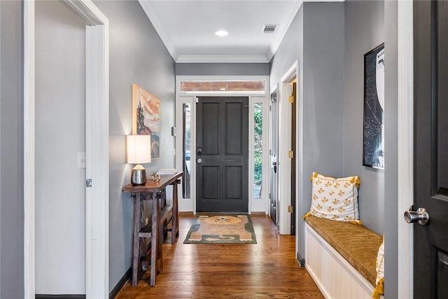 foyer with crown molding and dark hardwood / wood-style floors