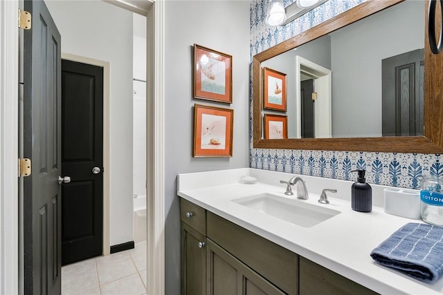 bathroom featuring vanity, tile patterned flooring, and a bathing tub