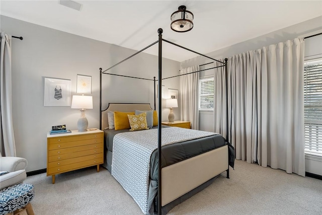 carpeted bedroom featuring multiple windows