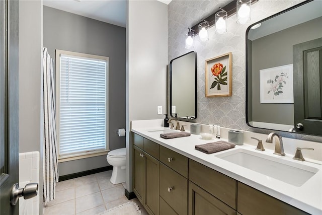 bathroom with vanity, tile patterned floors, and toilet