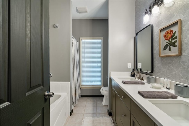 bathroom with tile patterned floors, vanity, toilet, and a bath