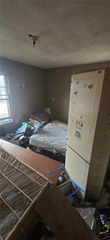 bedroom featuring white fridge