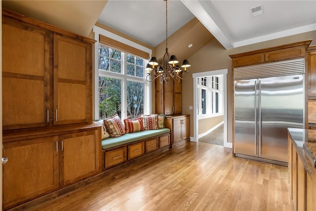 interior space featuring vaulted ceiling with beams, an inviting chandelier, and light hardwood / wood-style floors