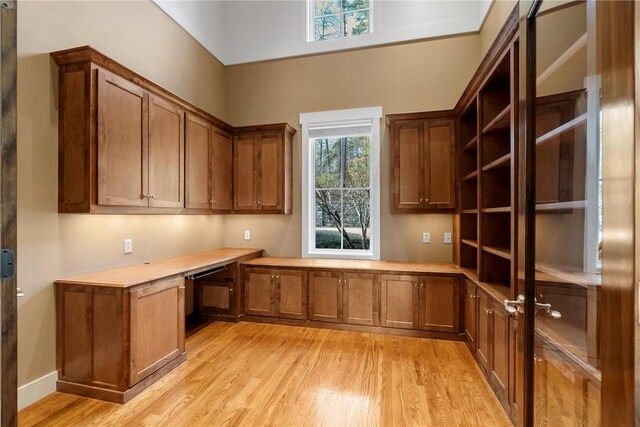 interior space with built in desk and light wood-type flooring