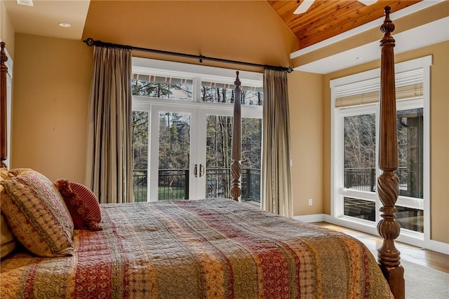 bedroom featuring light wood-type flooring, access to outside, french doors, and vaulted ceiling