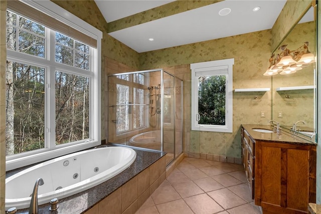 bathroom with plenty of natural light, plus walk in shower, tile patterned flooring, and vanity