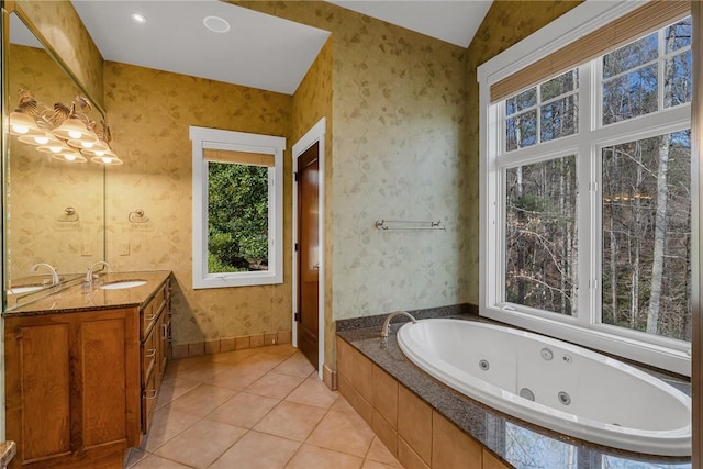 bathroom featuring vanity, a relaxing tiled tub, and tile patterned floors