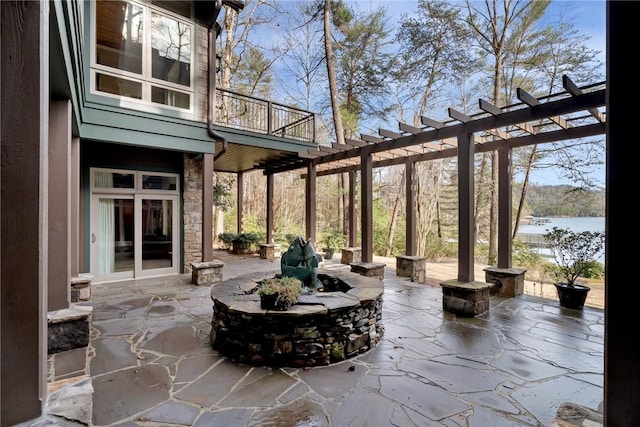 view of patio / terrace featuring a water view, a balcony, and a pergola