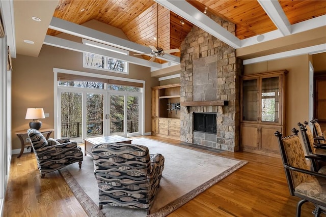 living room featuring french doors, wood-type flooring, a fireplace, and wooden ceiling