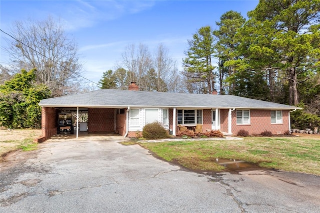 single story home featuring a front yard and a carport