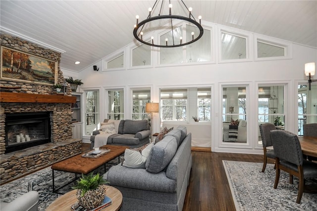 living area featuring a chandelier, dark wood-type flooring, a fireplace, and wood ceiling